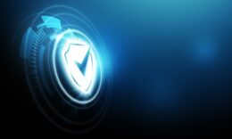 Glowing digital shield icon representing cyber security, data protection and secure technology systems on a blue futuristic background.